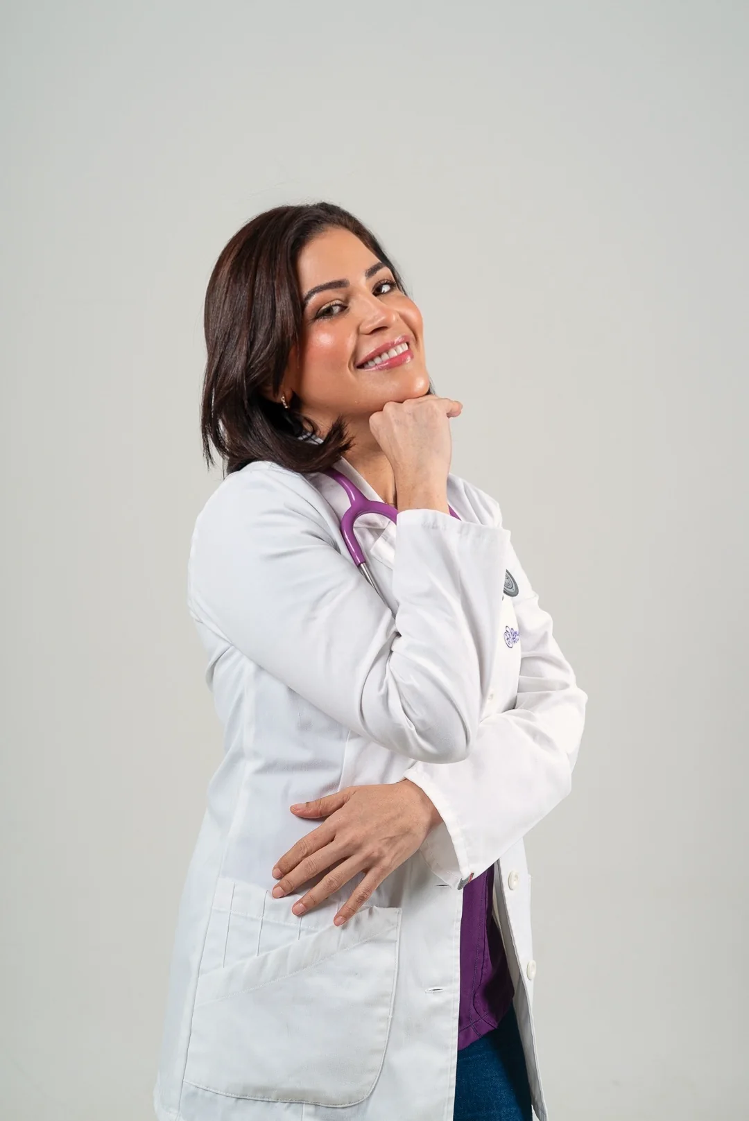 La doctora sonríe con la mano en el mentón